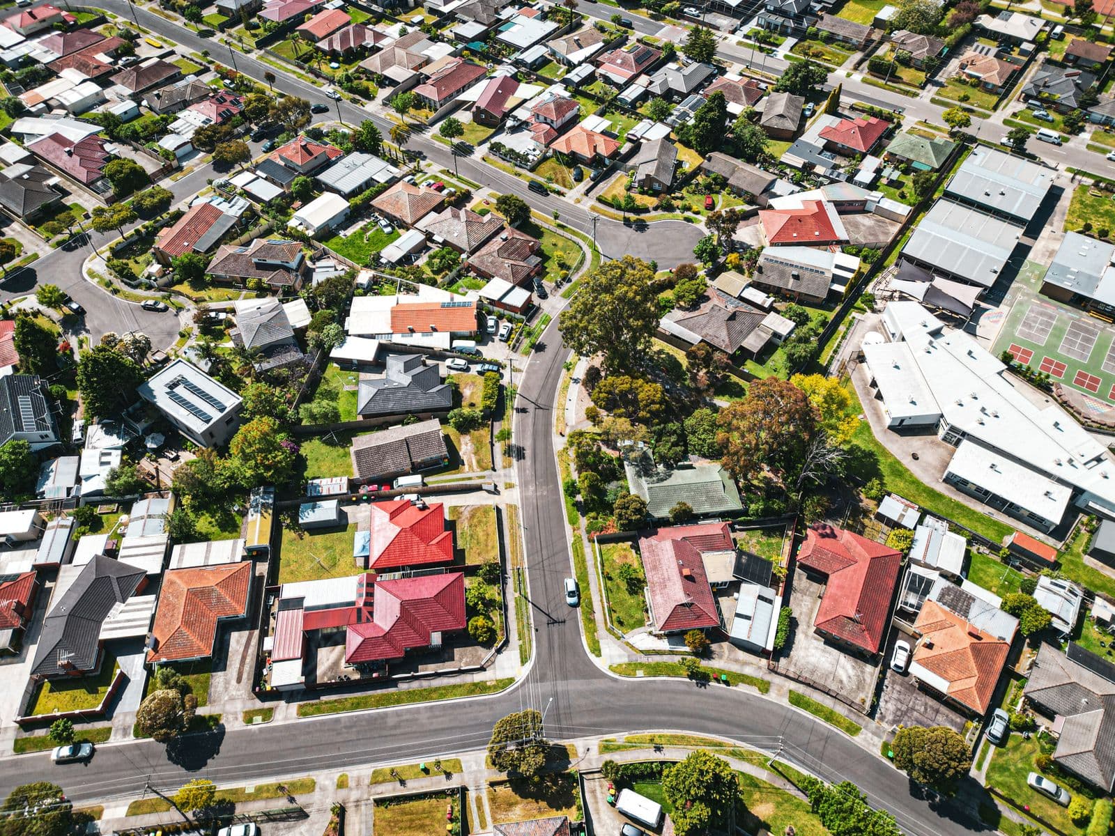 An aerial view of a suburban Melbourne street lined with houses and trees.